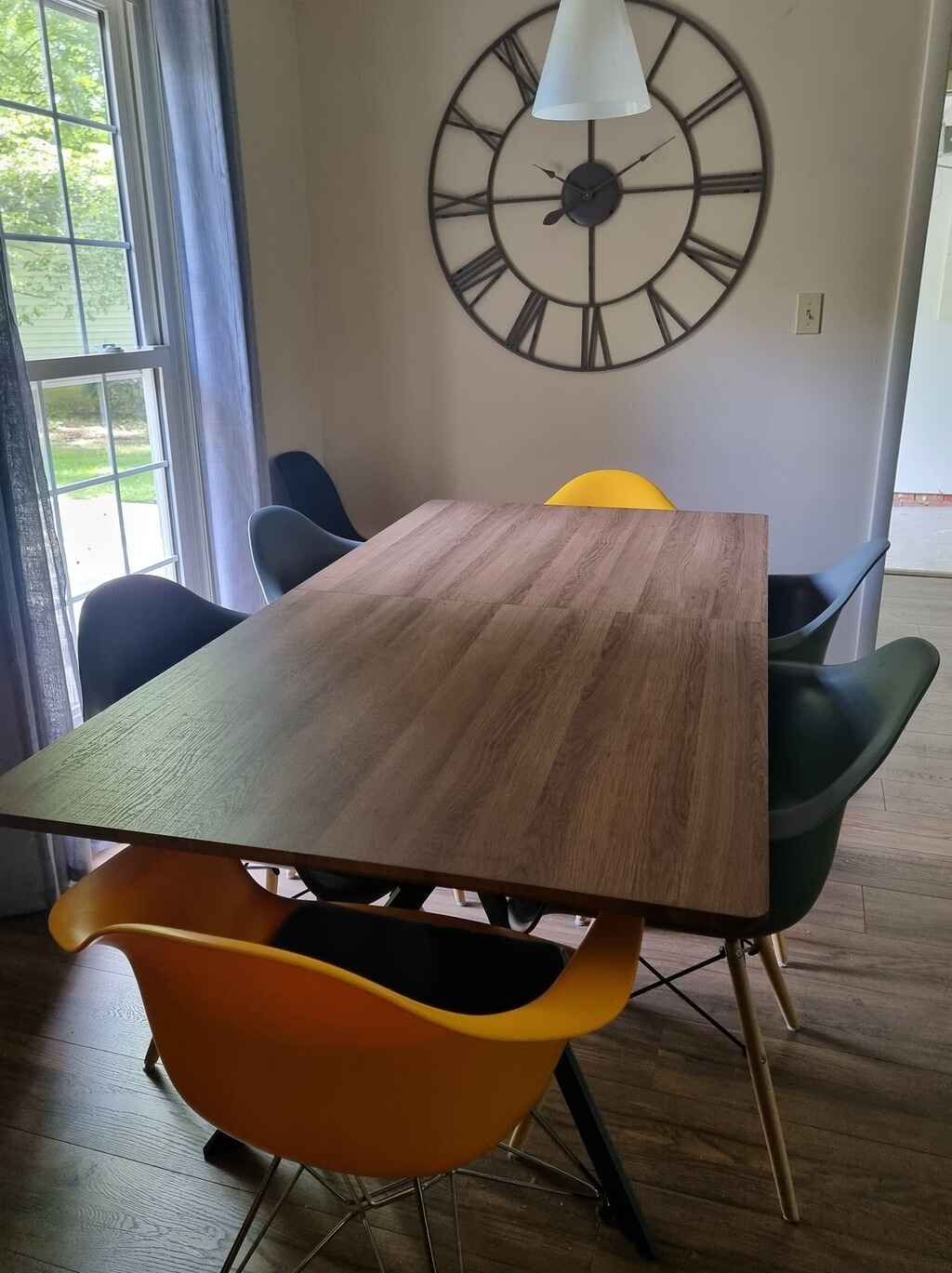 Modern dining area with wooden table and designer chairs
