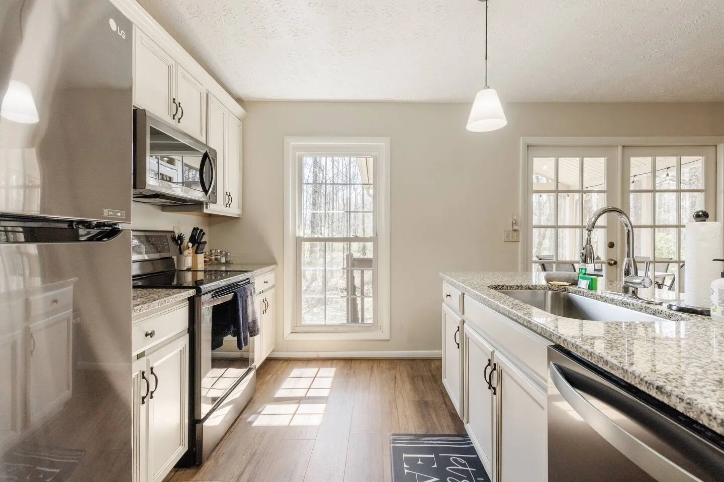 Kitchen with forest view and granite countertops