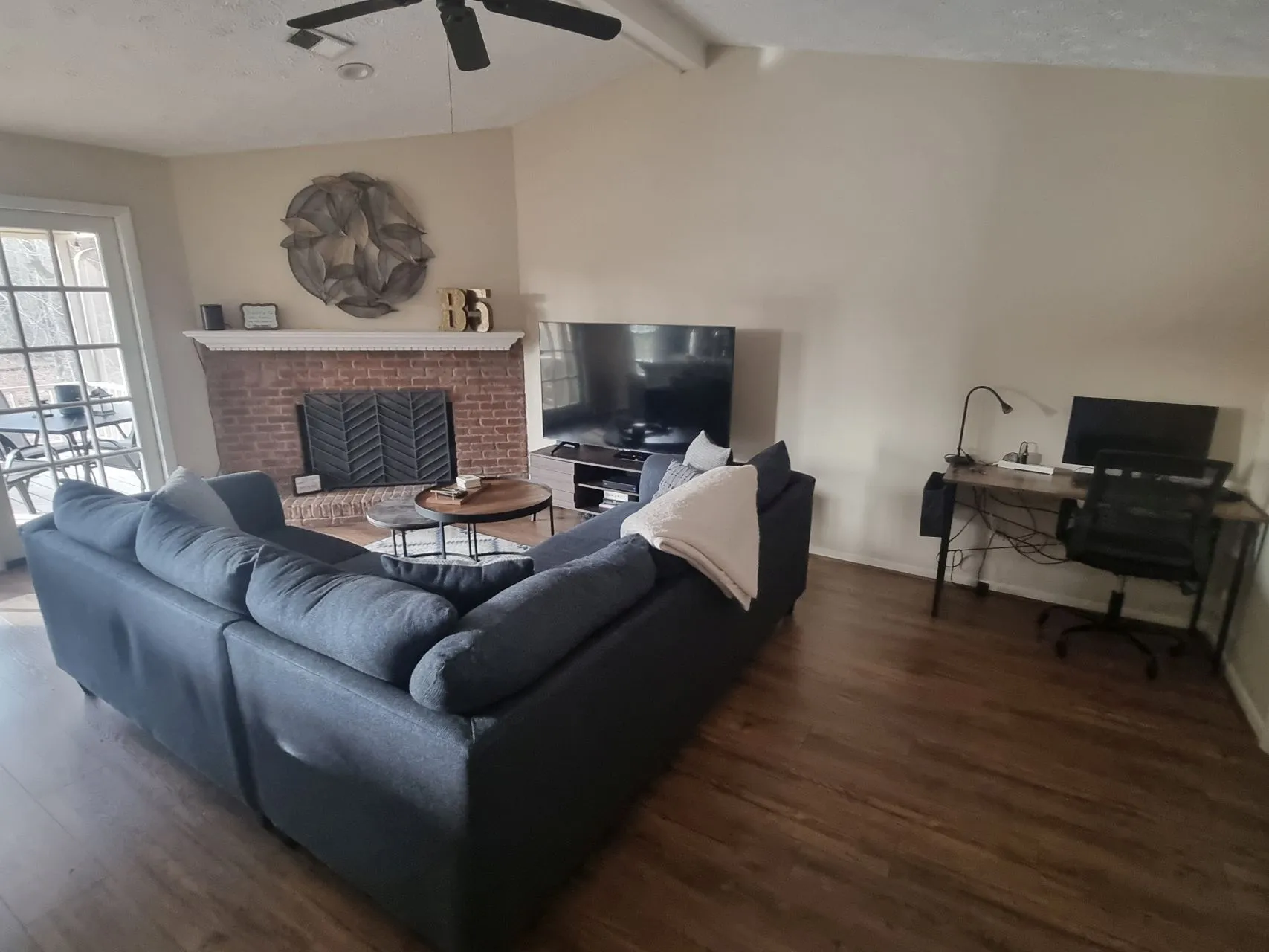 Spacious living room with sectional sofa and fireplace
