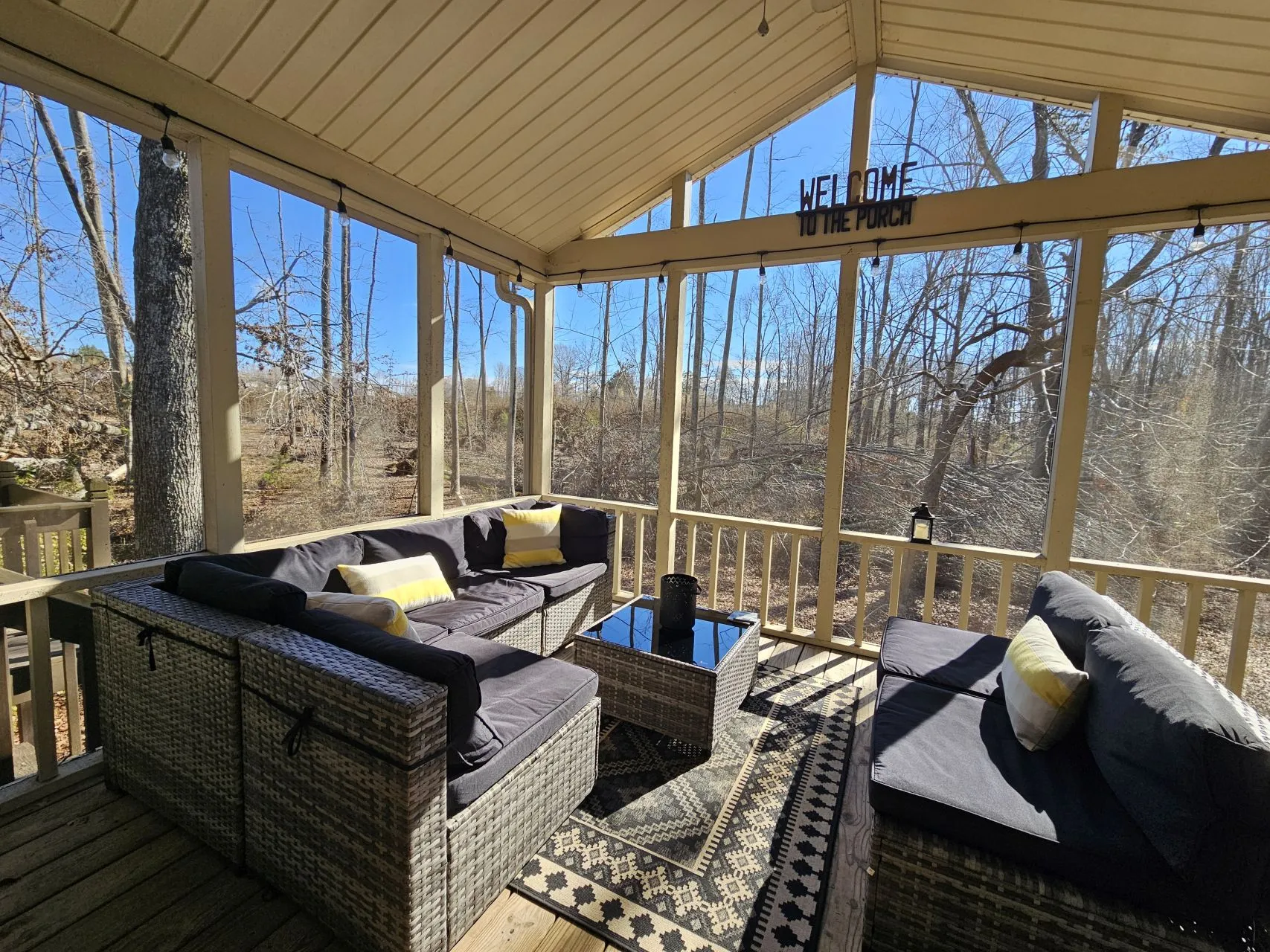 Screened porch with wicker furniture and woodland views