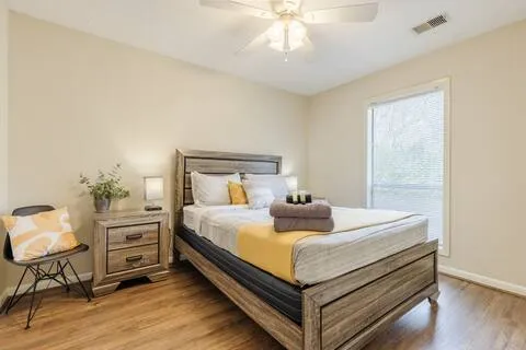 Guest bedroom with queen bed and yellow accents